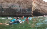 Customers navigating on bodyboards to the Benagil Cave